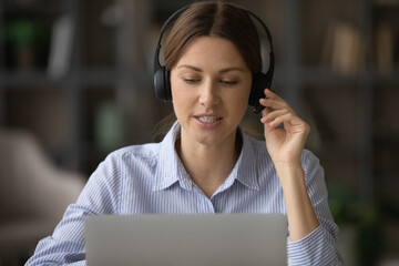 Remote consultant. Confident millennial female client support assistant sit at workplace by laptop...