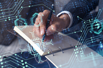 Hands writing down some ideas to create innovative software to change the world and provide a completely new service. Close up shot. Hologram tech graphs. Concept of Dev team. Formal wear.