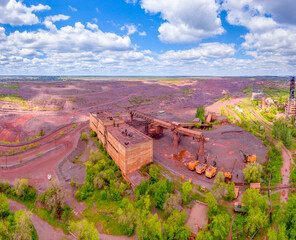 The building of an old mine for the extraction of iron ore.  Orange land.  Iron ore mine.  Quarry for the extraction of ore.  View from above.  Panoramic photo.
