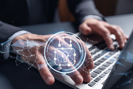 A programmer is typing a code on computer to protect a cyber security from hacker attacks and save clients confidential data. Padlock Hologram icons over the typing hands. Formal wear.