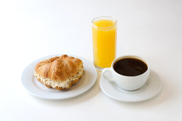 breakfast of coffee, orange juice and croissant.