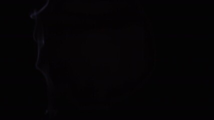 Matchstick falling in the dark in slow motion