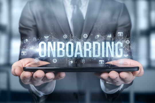 Businessman shows on the tablet the word onboarding .