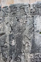 Detail of Mayan wall carving on the territory of Chichen Itza, Yucatan, Mexico. Ancient Mayan stone reliefs at Chichen Itza ruins, mexican archaeological site.