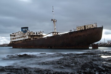 Stranded and abandoned ghost ship on the coast