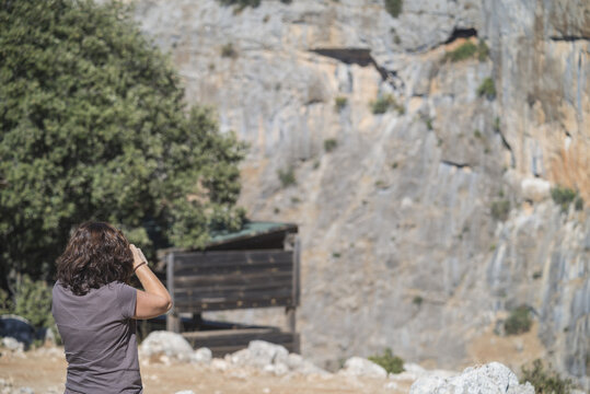 Woman photographing the rocks in Sierras de Cazorla, Segura and Las Villas Natural Park, Jaen, Spain