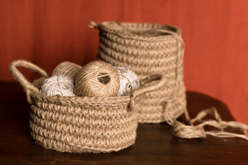 Obraz premium jute crochet material kit: threads, crochet hooks and leather tags in a basket on table