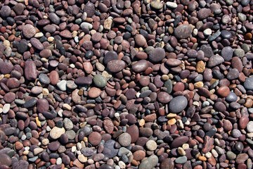 Red pebble stones on a beach