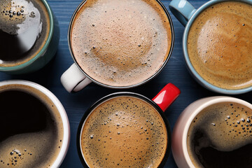 Many different cups of coffee on blue wooden table, flat lay