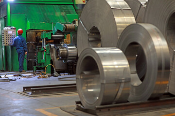 Workers are busy on the strip production line in an iron and steel company.