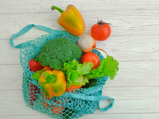 vegetables in an eco grid on a wooden background