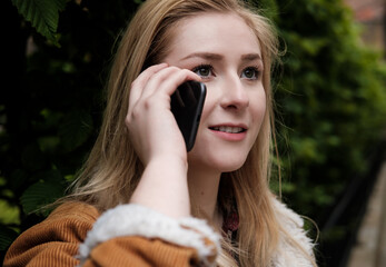 Headshot of a young woman using her smartphone.