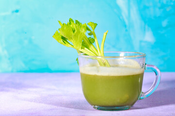 Healthy Celery diet for the treatment of incurable mysterious diseases. Fresh celery juice squeezed out on a juicer.drink, vegetable juice, studio shot