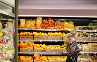 Woman buying fruits and vegetables at the market