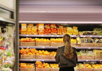 Woman buying fruits and vegetables at the market