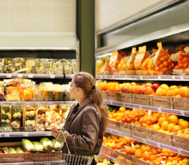 Woman buying fruits and vegetables at the market
