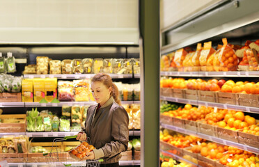 Woman buying fruits and vegetables at the market