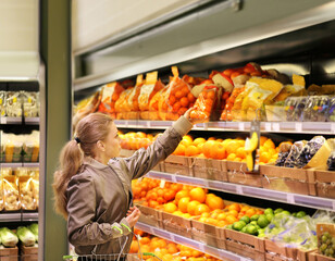 Woman buying fruits and vegetables at the market