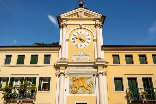View on a palace with ancient clock and lion of the Serenissima in Valstagna, Vicenza - Italy