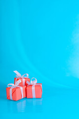 Red Gift Boxes On Sky Blue Background.Greeting card with copy space.