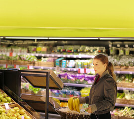 Woman buying fruits and vegetables at the market