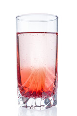 Glass with cranberry syrup close up isolated on white background
