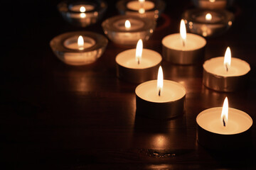 Obraz na płótnie Canvas burning candles on wood table