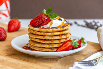 Home made Fresh Pancake with Honey and Strawberry Syrup and Strawberry topping 