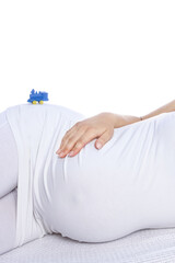 Happy pregnant girl lies on white background