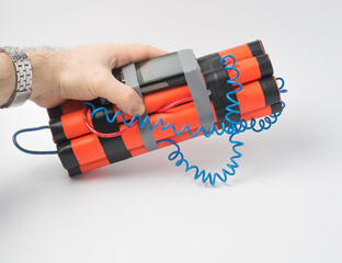 a man is holding a bomb with a timer made from a smartphone. survival and terrorism concept. white...
