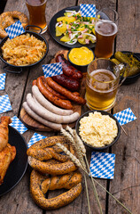 Oktoberfest dishes with beer, pretzel and sausage