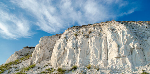 Fototapeta premium Ancient multimillion chalk mountains against the blue sky. Natural Chalk mining