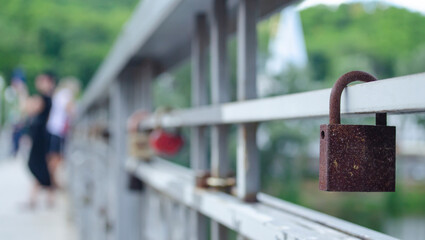 Old rusty Lock on the fence of the bridge. Lovers lock their love with a padlock. Old strong love