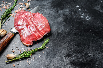 Raw Flat Iron steak black Angus. Fresh Marble beef meat. Black background. Top view. Copy space