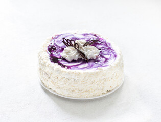 Sponge cream cake with blueberries on a white background