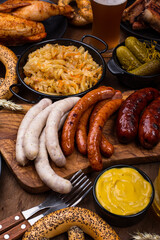 Oktoberfest dishes with beer, pretzel and sausage