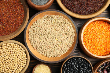 Different grains and seeds on wooden table, flat lay. Veggie diet