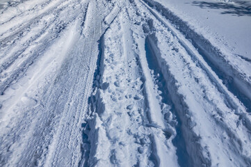 Fototapeta na wymiar Tire Tracks In Snow