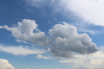 Clouds on bright blue sky background