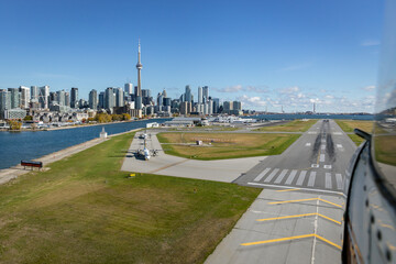 Billy Bishop Airport taxiway and runway with City of Toronto Skyline