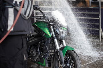 Motorcycle clean service. Employees are washing motorbikes.