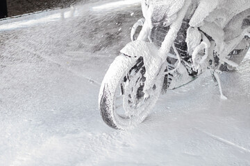 motorcycle in foam at a car wash. copyspace