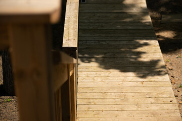 Cottage staircase.  Wooden cottage deck stairs.  Brown wooden stairs angled downwards.
