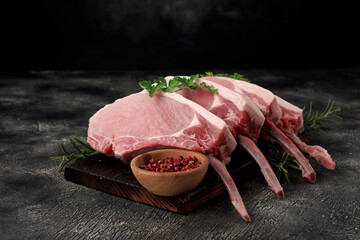 Pork meat with bones on wooden board