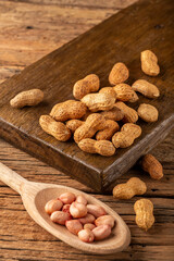 Dry peanut on the wooden background.
