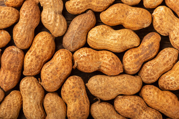 Dry peanut on the wooden background.