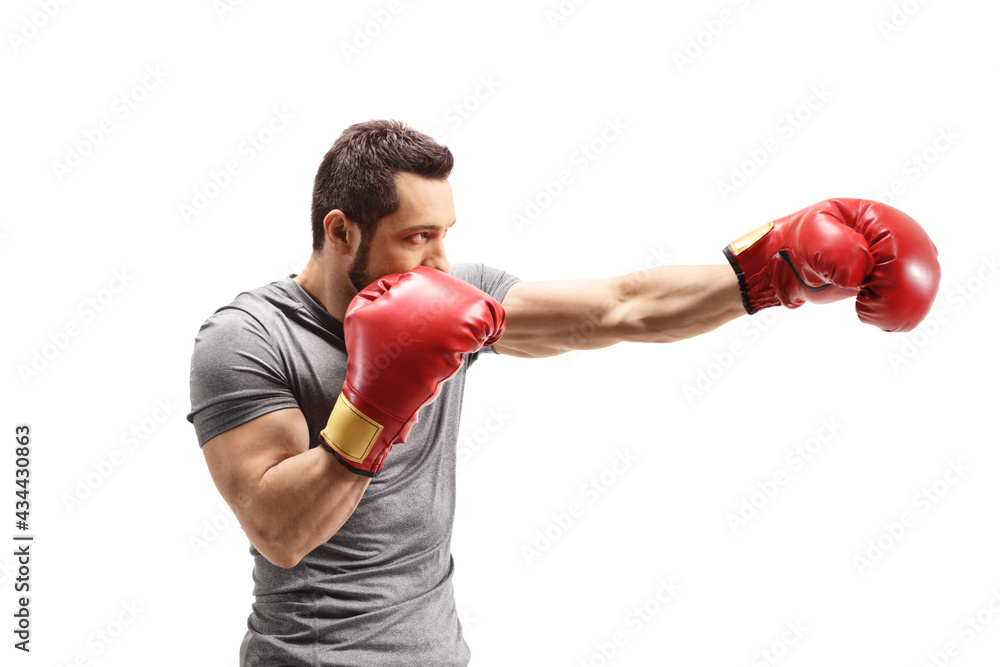 Poster Strong young man punching with boxing gloves