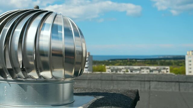 Rotary deflector on the apartment house rooftop.