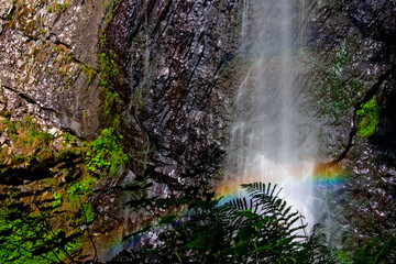 Fototapeta na wymiar Cascade du Queureuilh au mont dore en pose longue avec présence d'un arc en ciel