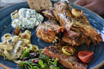 Goat meat cooked in tandoor, pasta and various appetizers. Traditional Aegean Islands food.